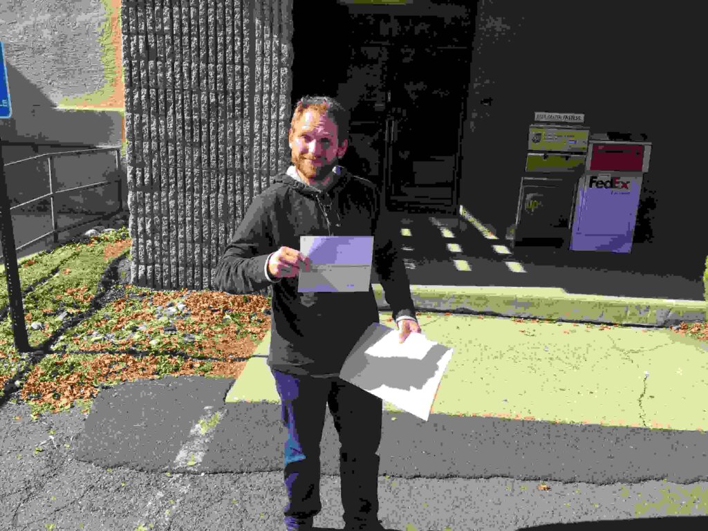 Brian holding his check at closing, after the sale of his house to Jeff Buys Houses Cash.