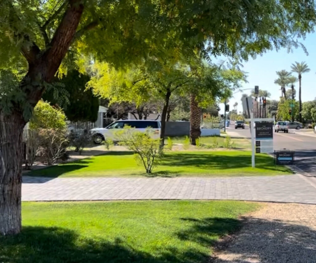 Local Arizona Real Estate Sign Pointing Towards Distressed Home in Foreclosure