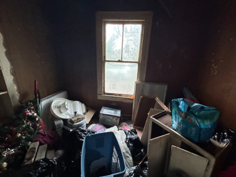 View of bedroom filled with junk and old items in occupied house needing repairs sold as in located in chattanooga, tn