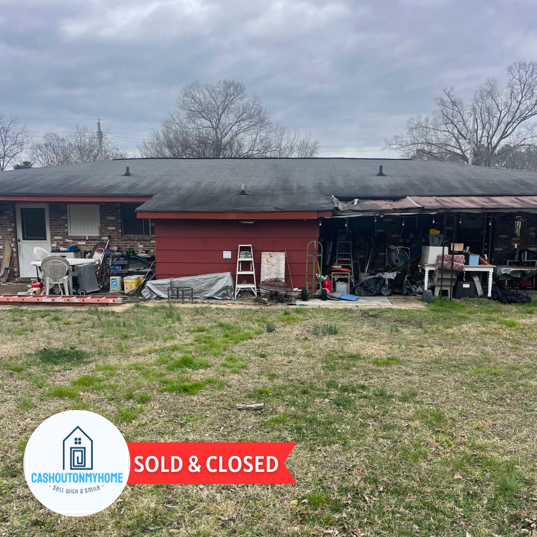 Duplex in Chattanooga in need of repair with red paint showing both apartments sold for cash
