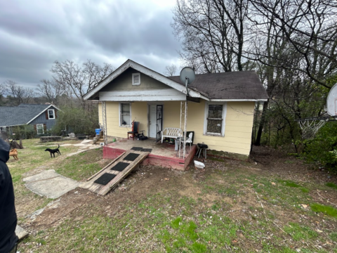 Front view of tenant occupied rental house in poor condition, highlighting significant deterioration and the need for extensive repairs that sold for cash in Chattanooga, TN