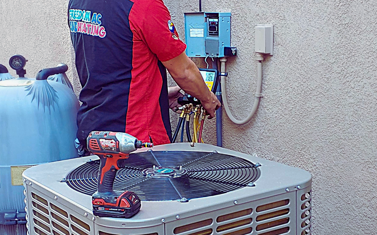 Freedom AC and Heating technician servicing rooftop AC unit – emergency HVAC repair in Southern California.