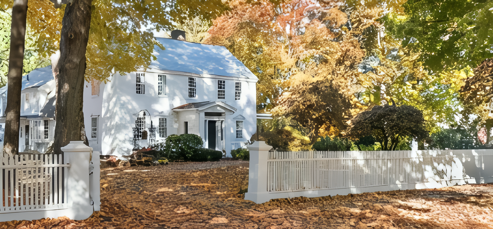 Charming white house surrounded by autumn foliage in Bridgewater, MA.