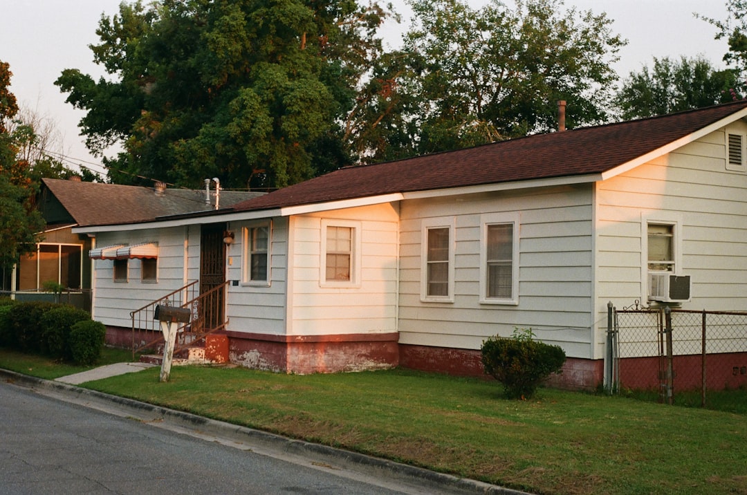 white and brown mobile home near green trees during daytime