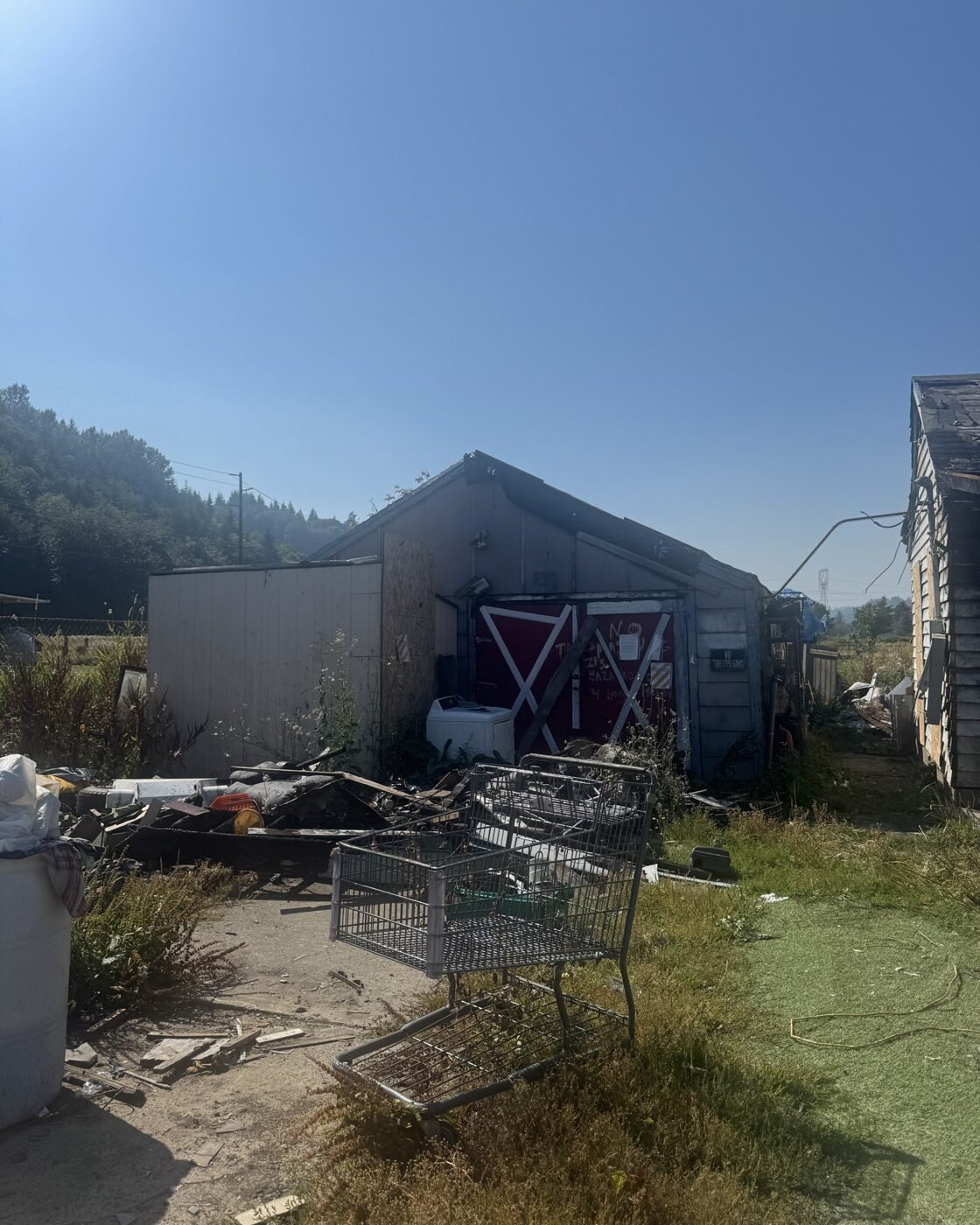 Back yard of the fire-damaged Longview house full of debris