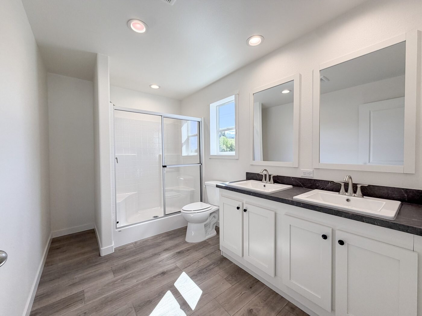 Main bathroom with a double vanity in the new Vader home