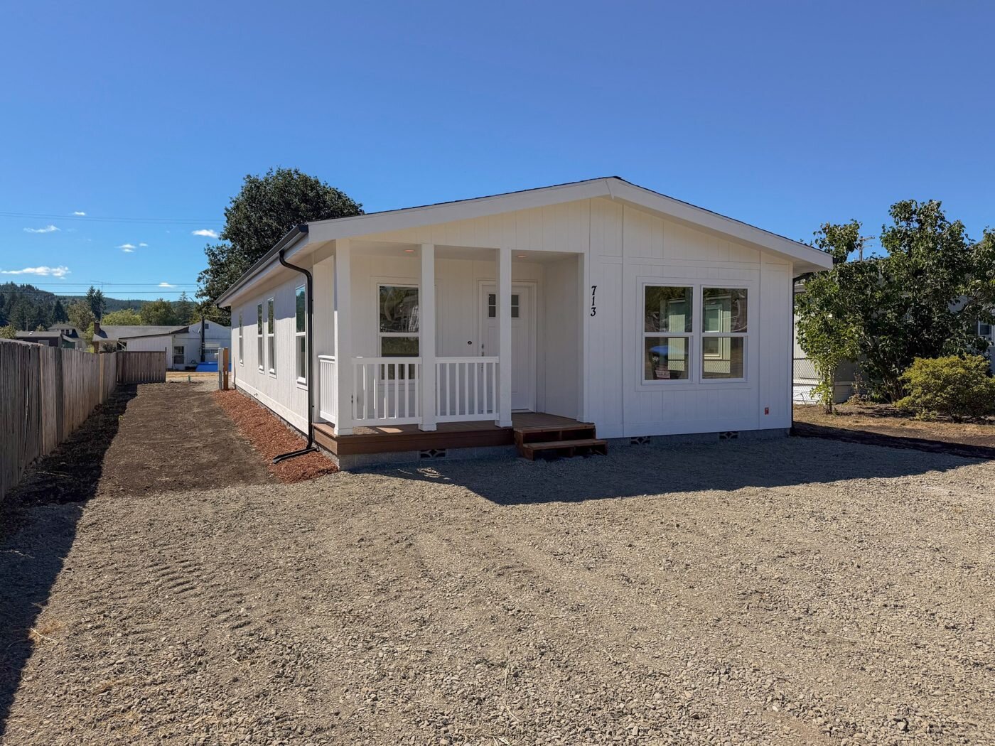 New manufactured home with a covered porch on the lot in Vader, WA