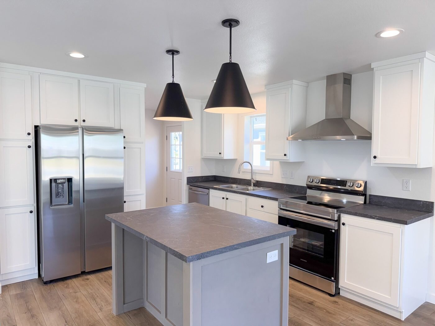 Kitchen in the new Vader home with white cabinets and an island