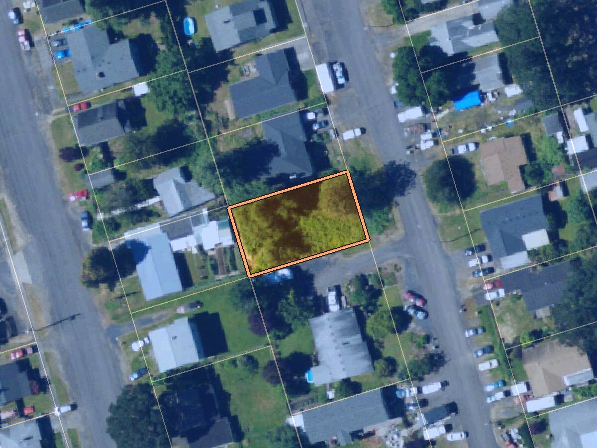 Aerial photo of a vacant city lot on South 16th Street in St. Helens, Oregon, outlined in orange