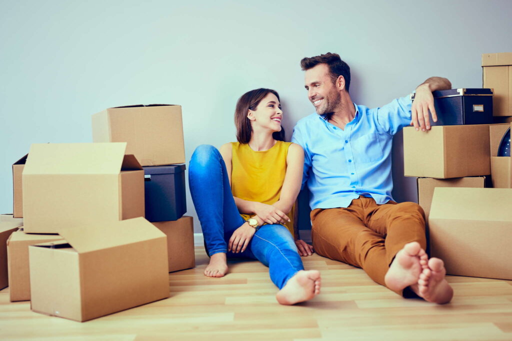 Homeowner packing moving boxes before selling a house fast in Erie, PA