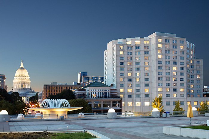 Nighttime view of downtown Madison, Wisconsin, featuring the Wisconsin State Capitol dome illuminated with surrounding buildings and the modern design of the Monona Terrace.