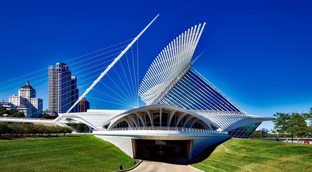 Milwaukee Art Museum with its iconic wing-like design, set against a clear blue sky.