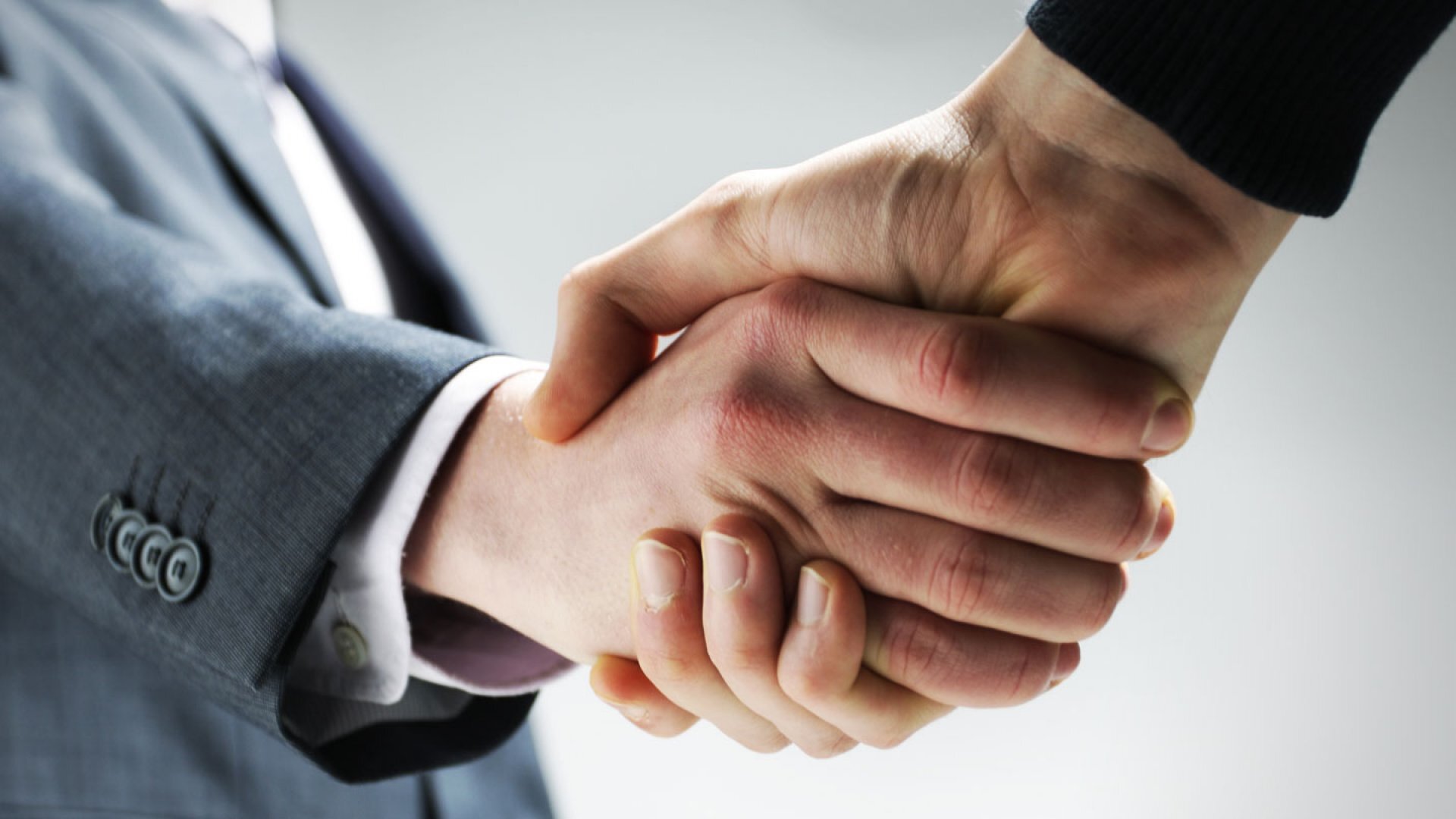 close-up of two people shaking hands, symbolizing a successful agreement or deal.