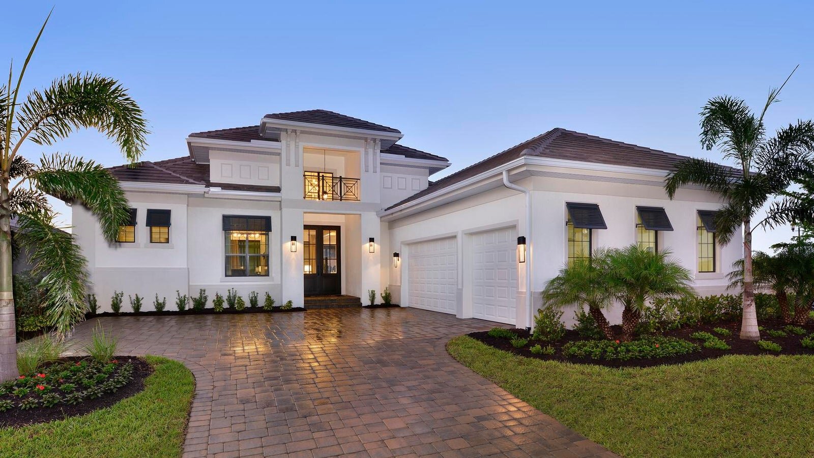 A row of charming suburban homes with varied exteriors, including a mix of colors and porch designs. Each house has a neatly manicured lawn and a pathway leading to the front door, creating a picturesque, community-oriented streetscape under a bright blue sky.