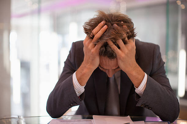 A person holding their head in frustration,