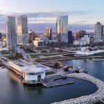 Aerial view of downtown Milwaukee along Lake Michigan at sunset.