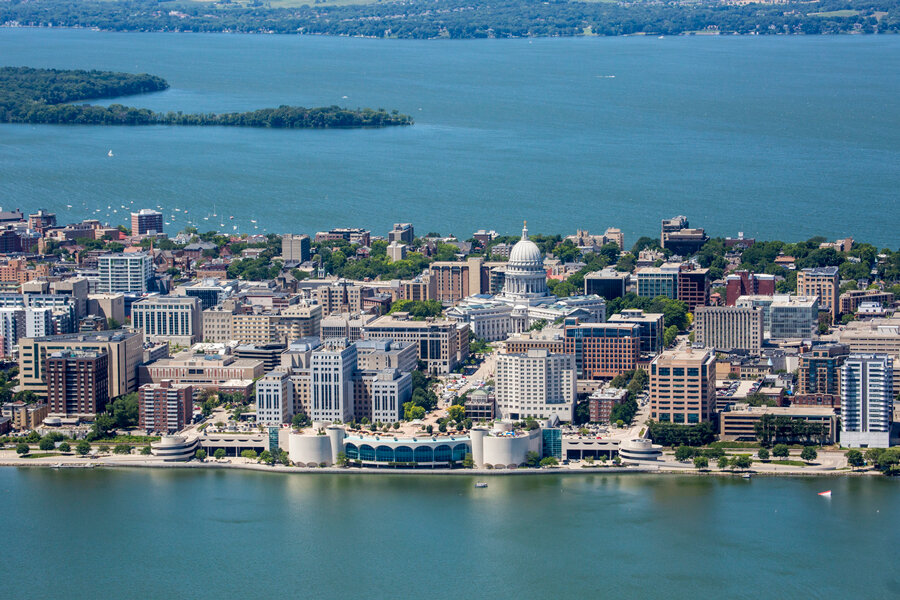 Aerial view of downtown Madison, Wisconsin, with the State Capitol and Lake Monona in the background.