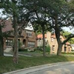 Tree-lined residential street in Wauwatosa featuring classic brick homes and well-maintained lawns.