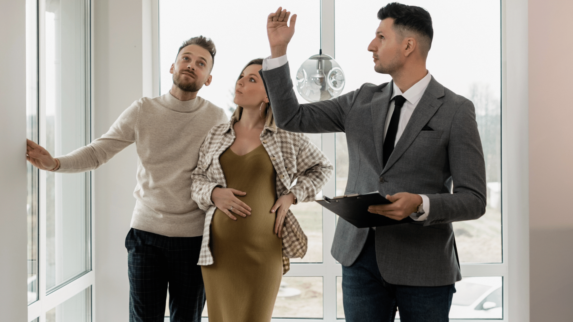 Real estate agent showing a home to potential buyers during a property tour.