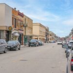 Downtown Kenosha, Wisconsin with historic buildings, streetlights, and a clear view of a quiet urban street.
