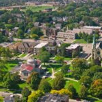 Aerial view of downtown Kenosha, WI with residential homes and green spaces — we buy houses in Kenosha.
