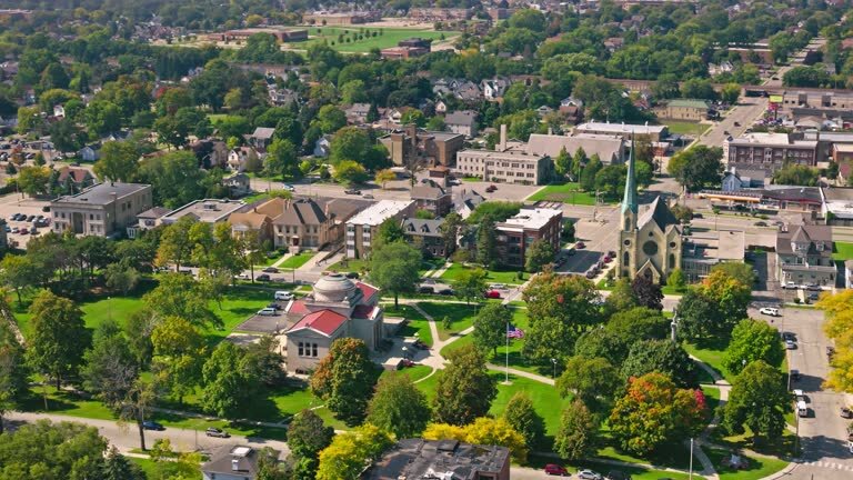 Aerial view of downtown Kenosha, WI with residential homes and green spaces — we buy houses in Kenosha.