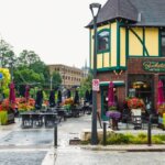 Outdoor dining area with colorful flowers and umbrellas outside Buckatabon Tavern on W. State Street in Wauwatosa, Wisconsin.