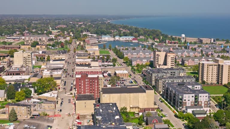 Aerial view of downtown Kenosha, Wisconsin, showing buildings, streets, and Lake Michigan in the background on a clear day