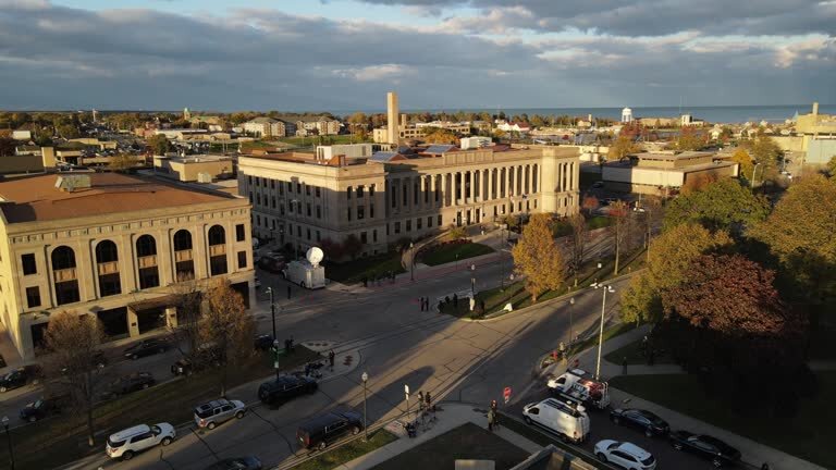 Aerial view of downtown Kenosha, Wisconsin, featuring historic buildings, autumn trees, and Lake Michigan in the background.