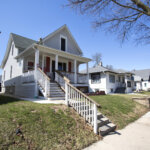 Residential street in West Allis featuring a row of well-kept single-family homes with porches on a sunny day.