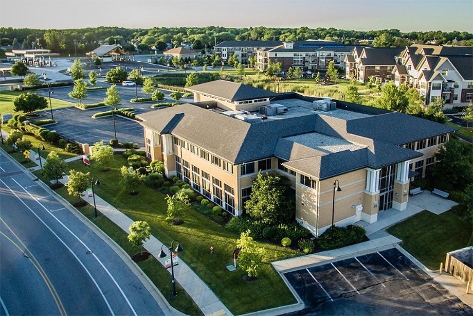 Aerial view of New Berlin City Center featuring modern office buildings, landscaped greenery, and surrounding residential apartments.