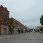 Downtown street in New Berlin with historic brick buildings and shops on a cloudy day.