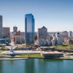 Aerial view of downtown Milwaukee skyline with tall buildings along the lakefront on a clear day.