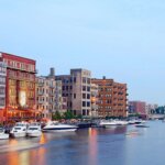 Colorful waterfront apartments and boats along the Milwaukee River at dusk