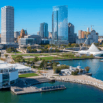 Milwaukee downtown skyline with tall buildings, lakefront park, and modern architecture along Lake Michigan on a clear day.
