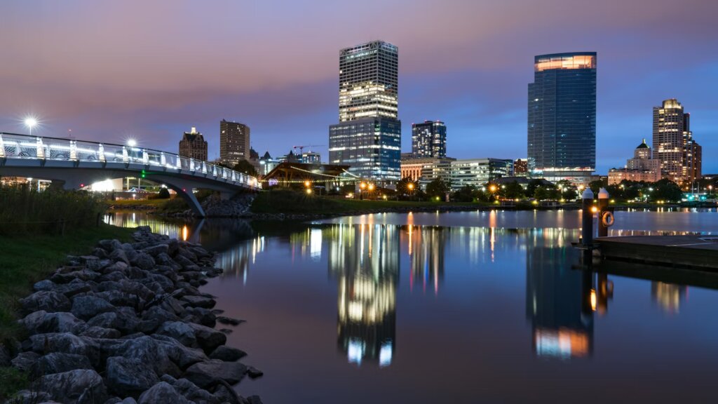 Scenic view of the Hank Aaron Trail in Milwaukee surrounded by trees and city skyline.