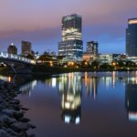 Scenic view of the Hank Aaron Trail in Milwaukee surrounded by trees and city skyline.