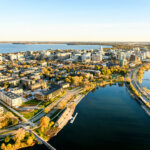 Aerial view of downtown Madison, Wisconsin, with lakeshore and city skyline at sunset.