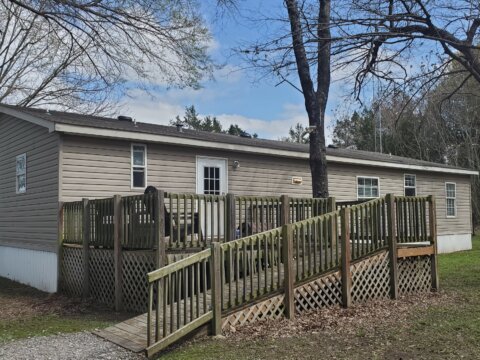 Large back deck on mobile home with ramp