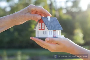 Inherited house represented by a small home held in hands