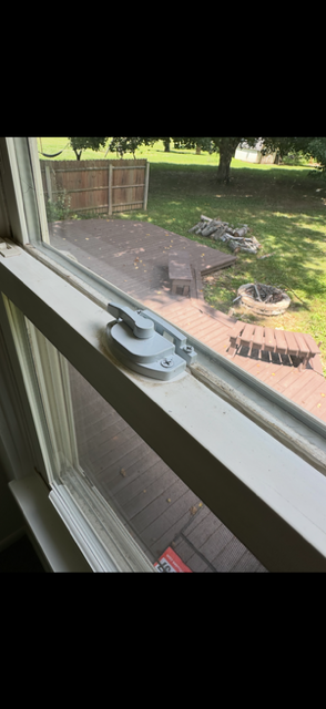 Window hardware and the view toward the deck at 1922 Old Coach Road