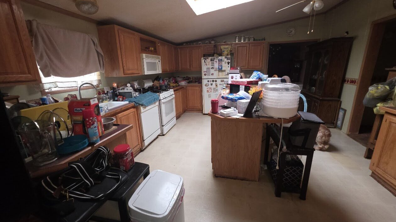 Cluttered kitchen in a house sold as-is for cash, the way owners sell their house as-is in Dayton