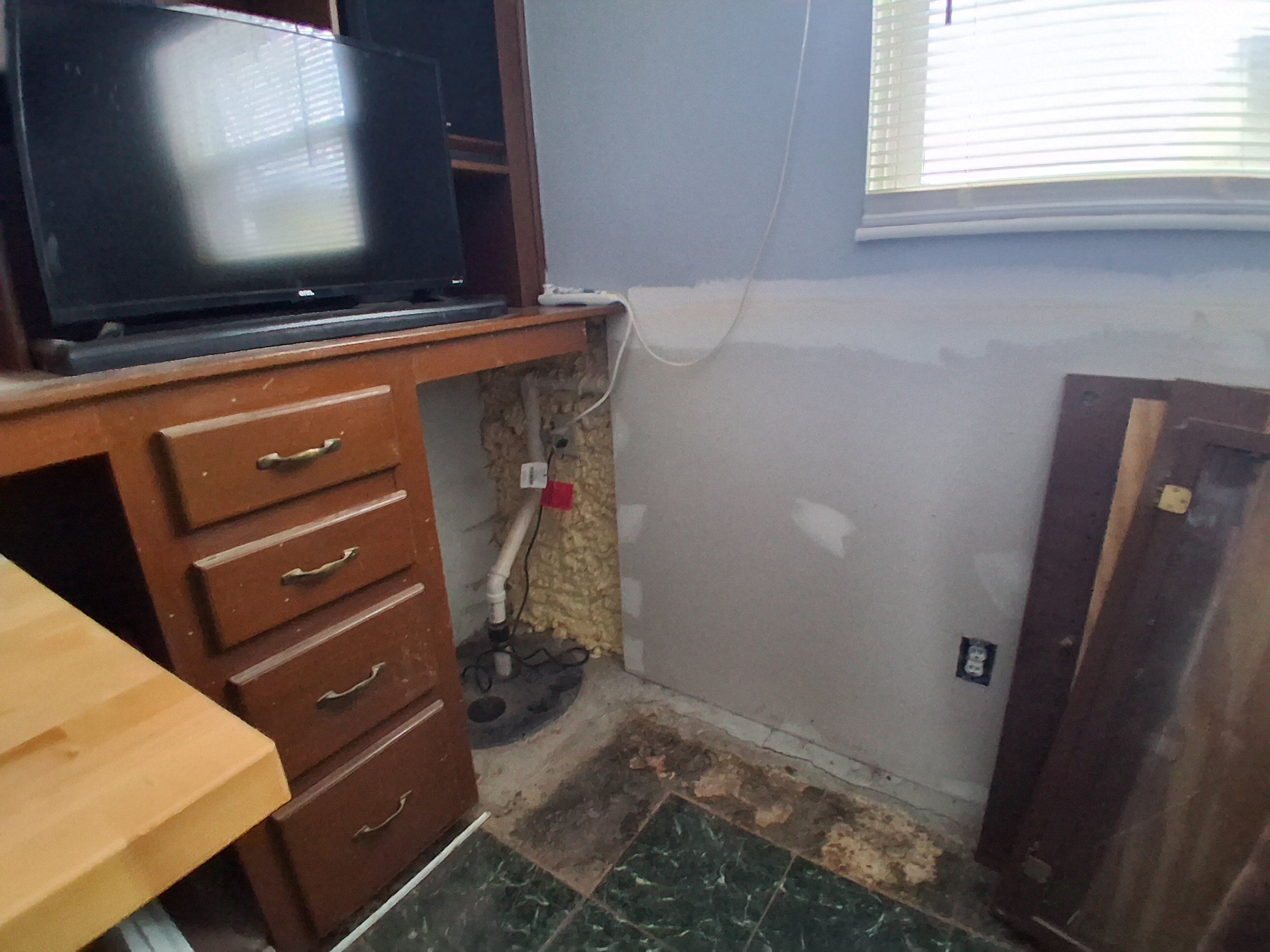 Built-in cabinetry and wall and floor condition at 1922 Old Coach Road before renovation