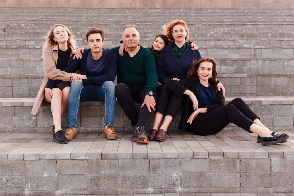a large family of children and parents. a family of six look into the camera. Teenage children