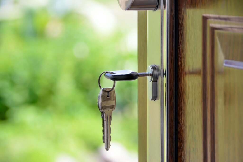 a key in the lock of a house that was just sold