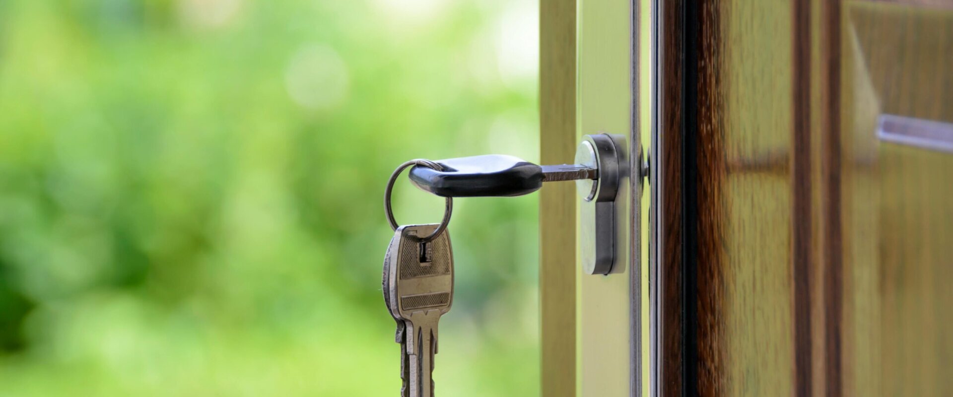 a key in the lock of a house that was just sold