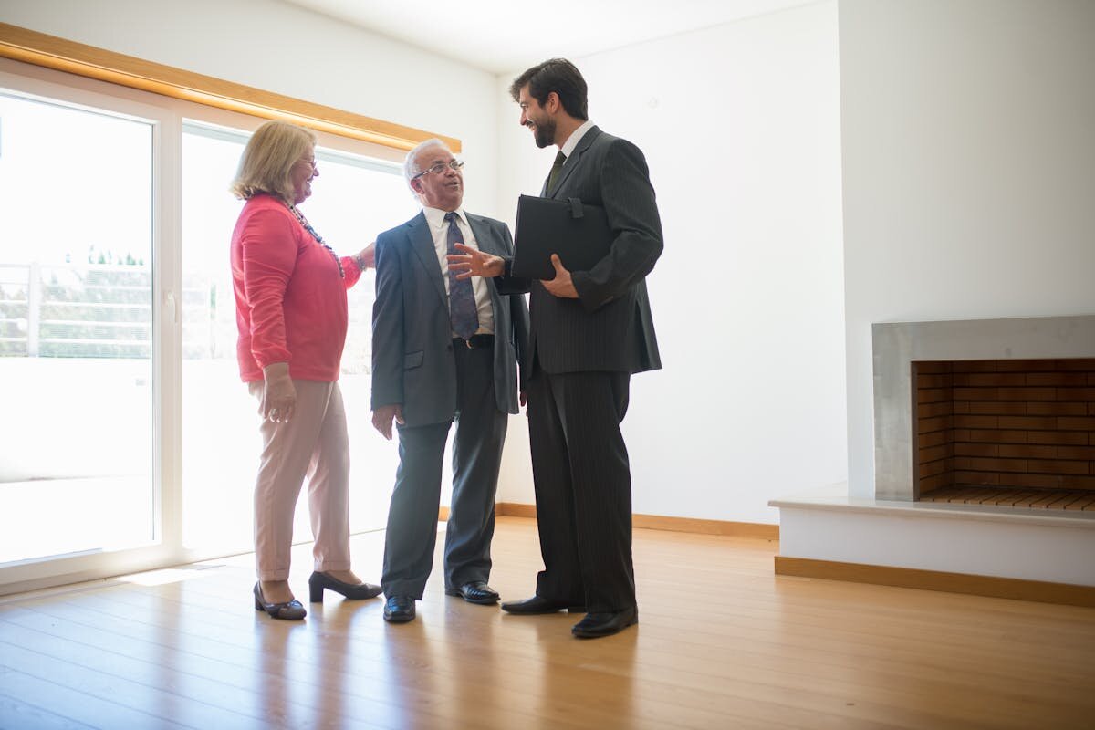 a realtor showing a house to some people for them to buy it