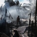 firefighters in a house that has burned down