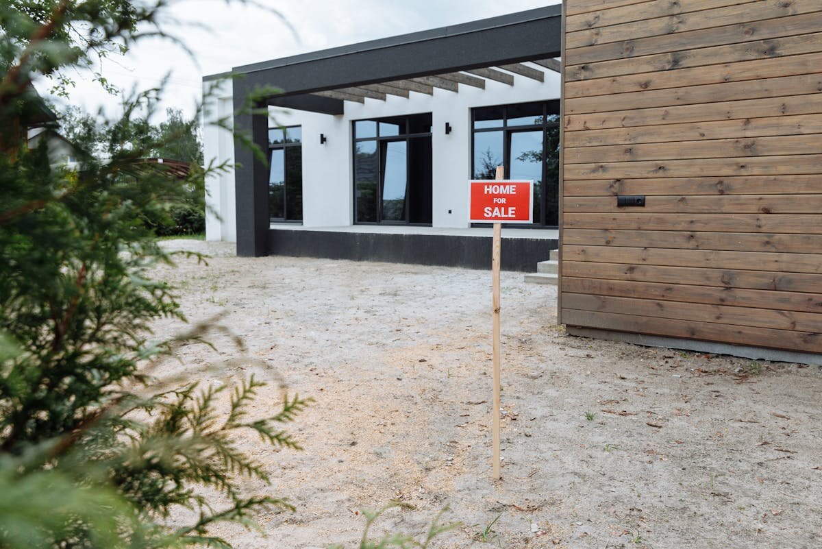 a house with a for sale sign outside