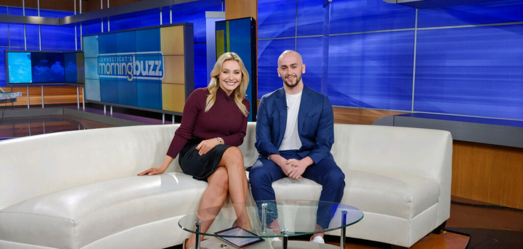 neighbor joe and a news anchor sitting on a couch